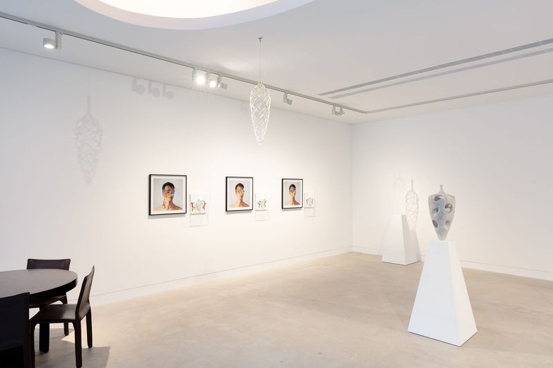 Installation view, Connectivity: New Explorations, Gallery Sally Dan-Cuthbert, 2023: Mask prints on wall, Dimensions of the Mind, suspended vessels.